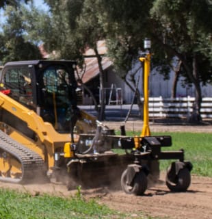 Cat compact track loader with grader blade